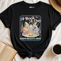 "A Book A Day Keeps Reality Away" T-Shirt | Cryptid Campfire Book Lover Graphic Tee & Fantasy Reader Shirt